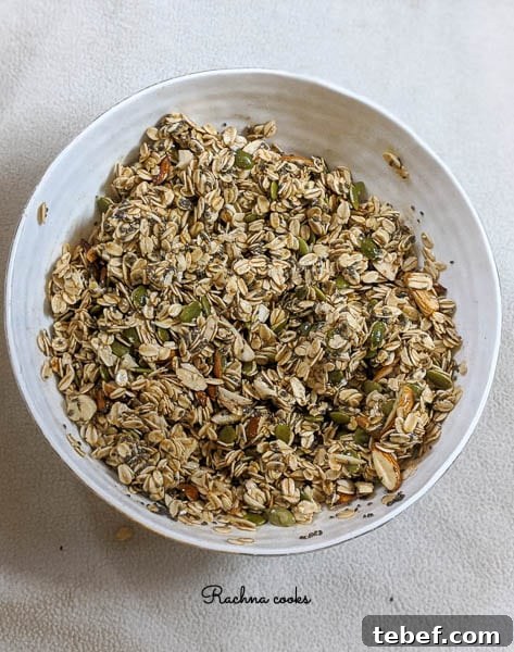 Crunchy Air Fryer Granola Recipe for Perfect Homemade Clusters 8 Granola mix in a white bowl ready to be baked.