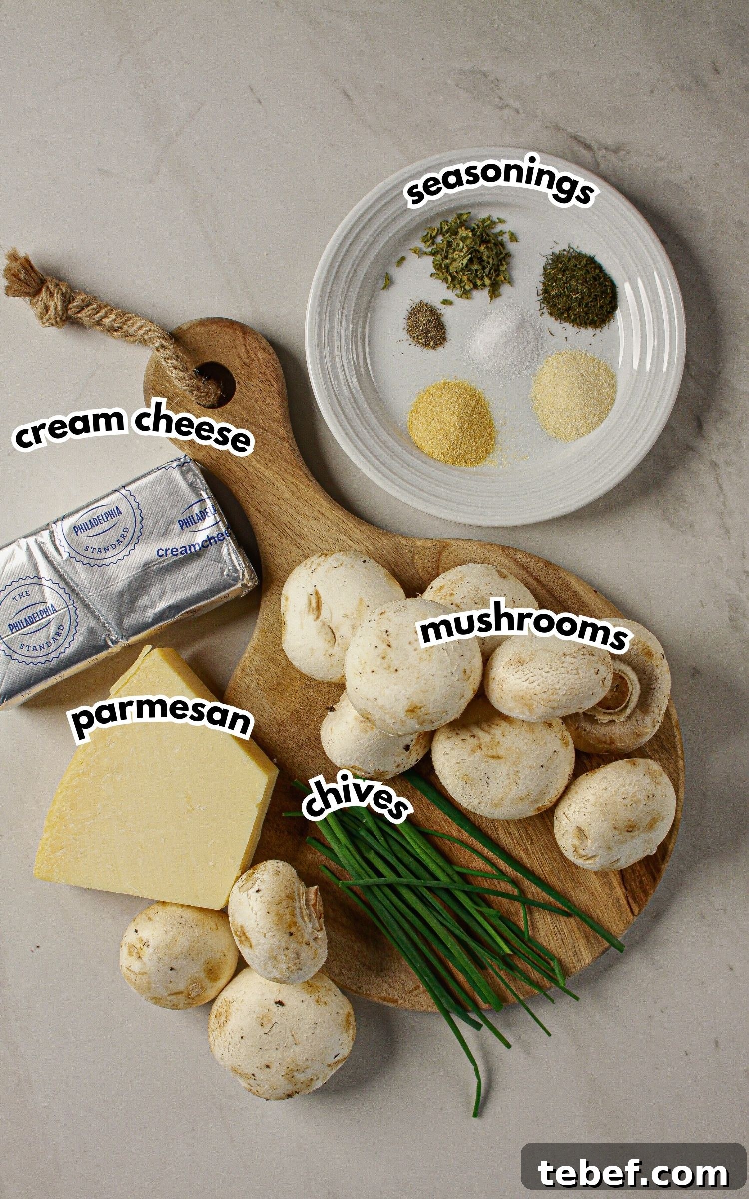 Cream Cheese Stuffed Mushrooms Recipe with Garlic and Herbs 4 Ingredients on a counter labelled with text.