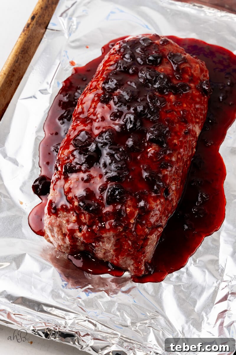 Bourbon-Glazed Bacon Meatloaf Recipe 4 The glaze is poured over the top of the uncooked meatloaf.