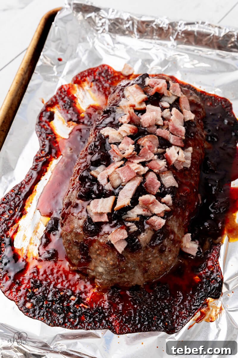 Bourbon-Glazed Bacon Meatloaf Recipe 5 The rest of the bacon is added to the top of the loaf.