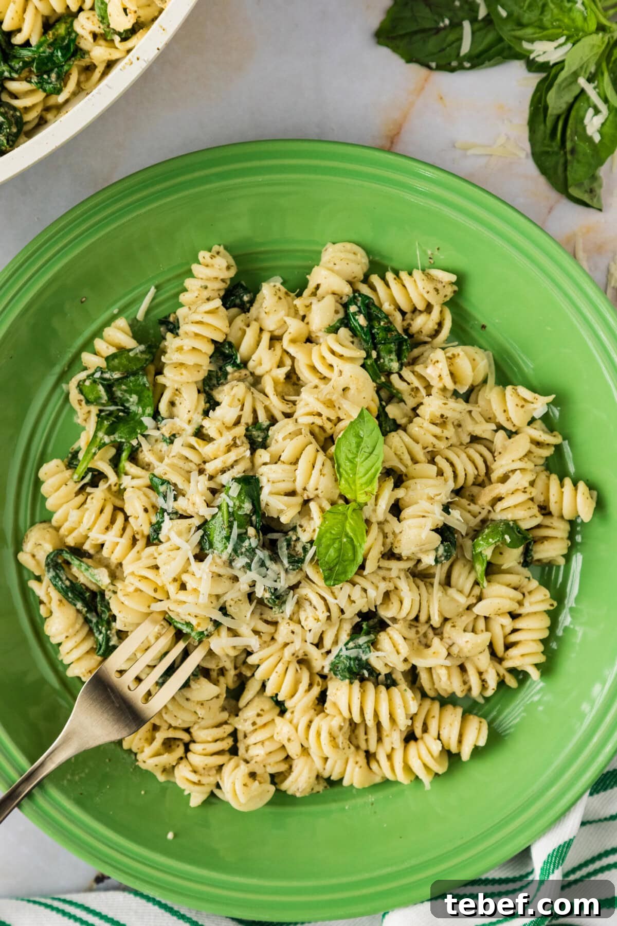 Creamy Basil Pesto Pasta with Parmesan and Pine Nuts 2 Plate of Pesto Pasta with a fork in it