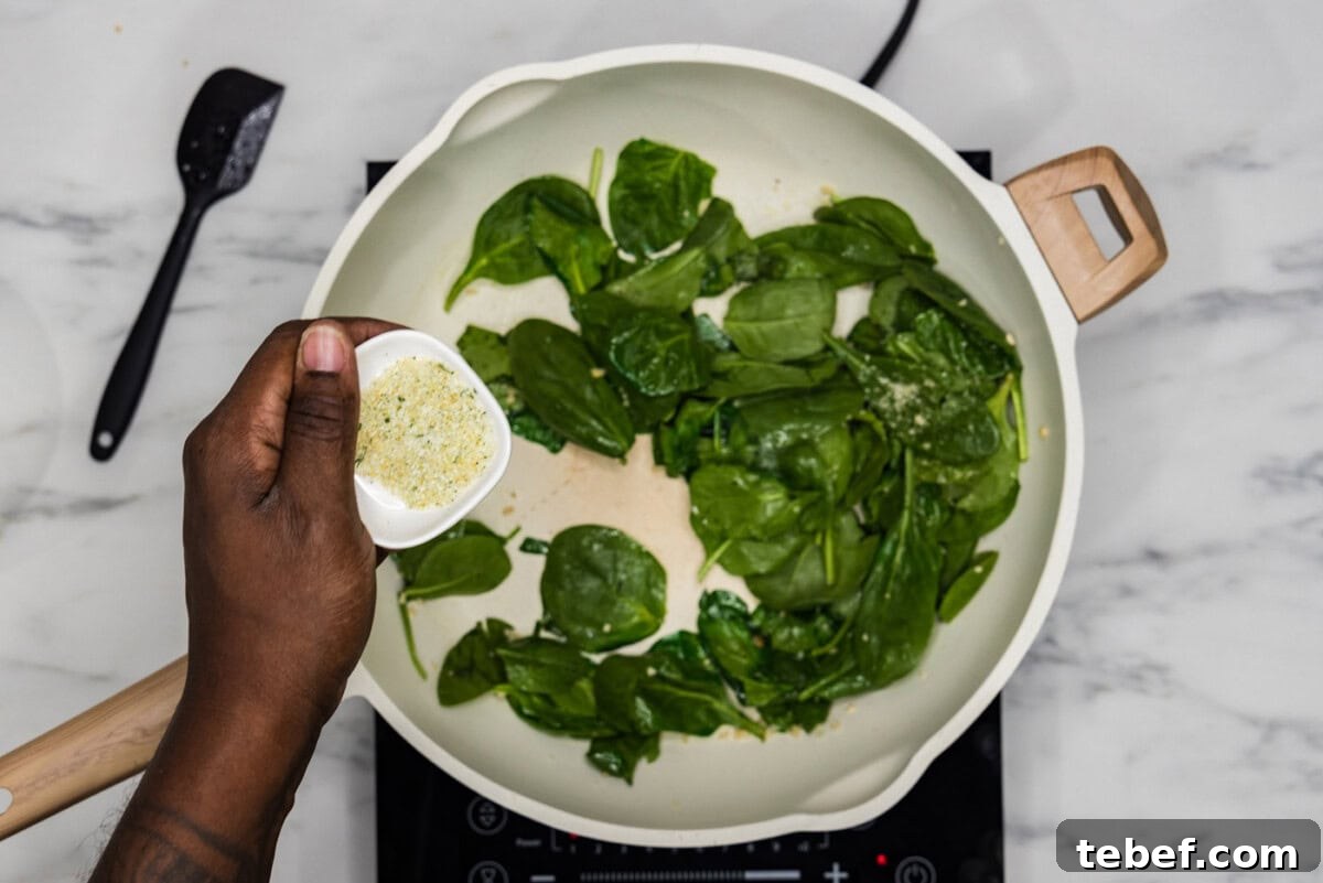 Creamy Basil Pesto Pasta with Parmesan and Pine Nuts 5 seasoning spinach in a skillet with garlic salt
