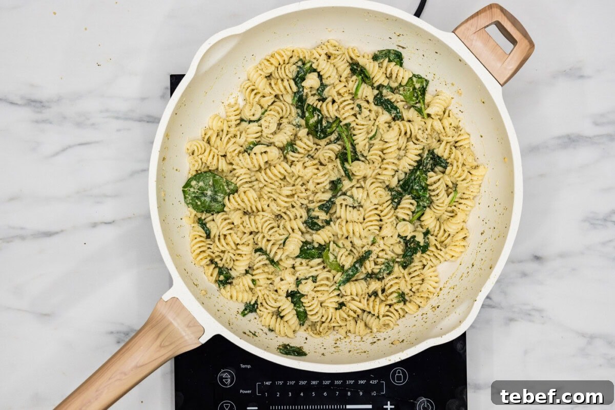 Creamy Basil Pesto Pasta with Parmesan and Pine Nuts 8 overhead of pesto pasta in a skillet