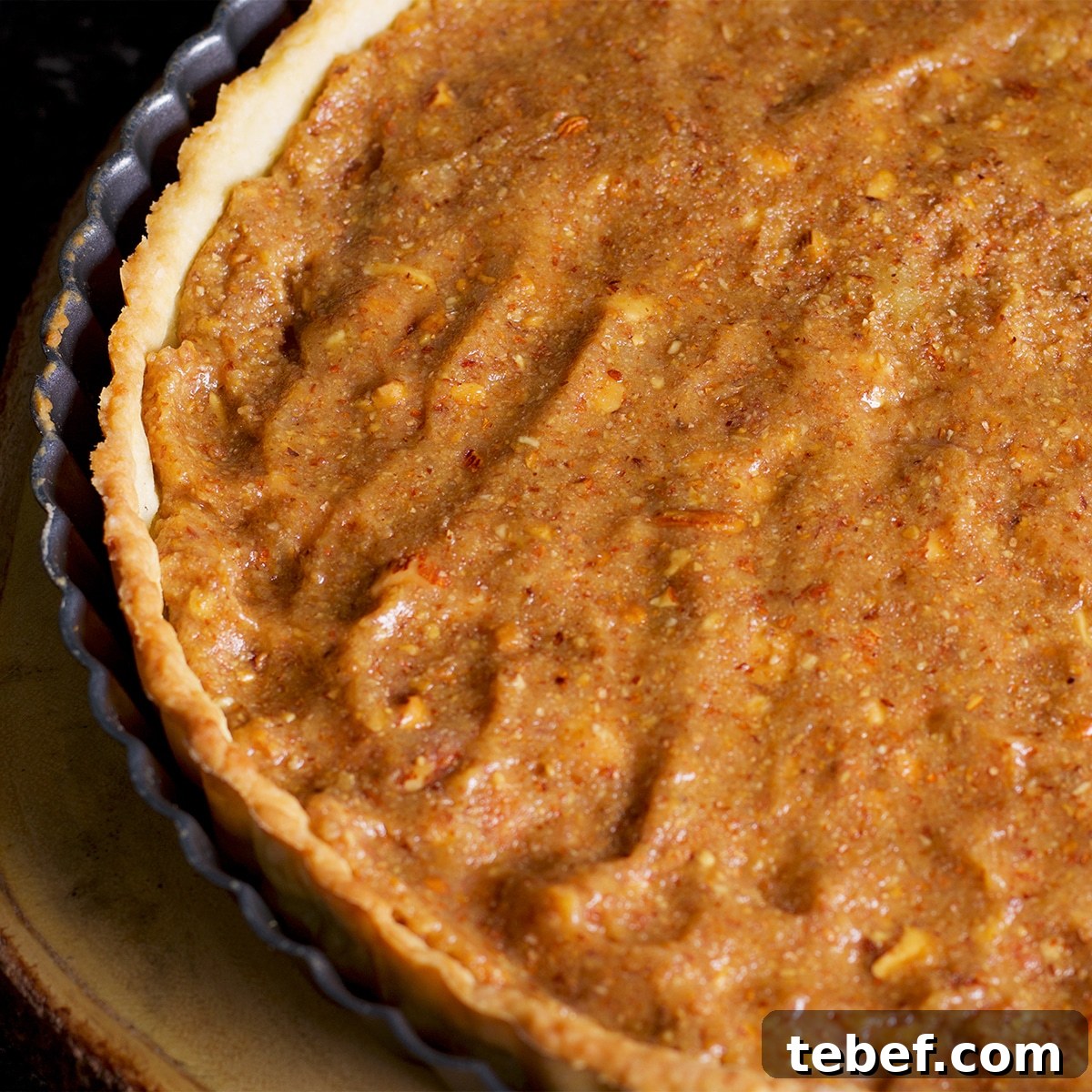 A tart shell that's been filled with frangipane.