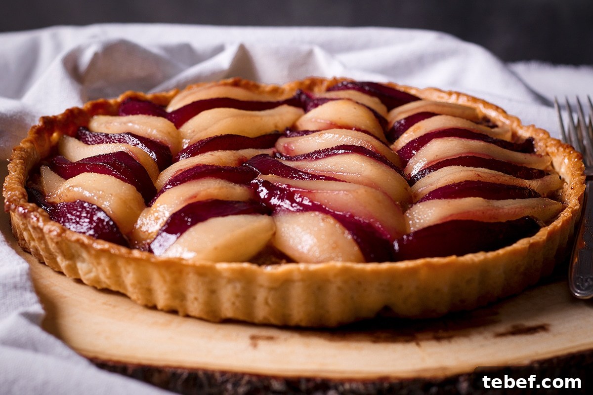 A poached pear and frangipane tart that's just been glazed with a white wine reduction.