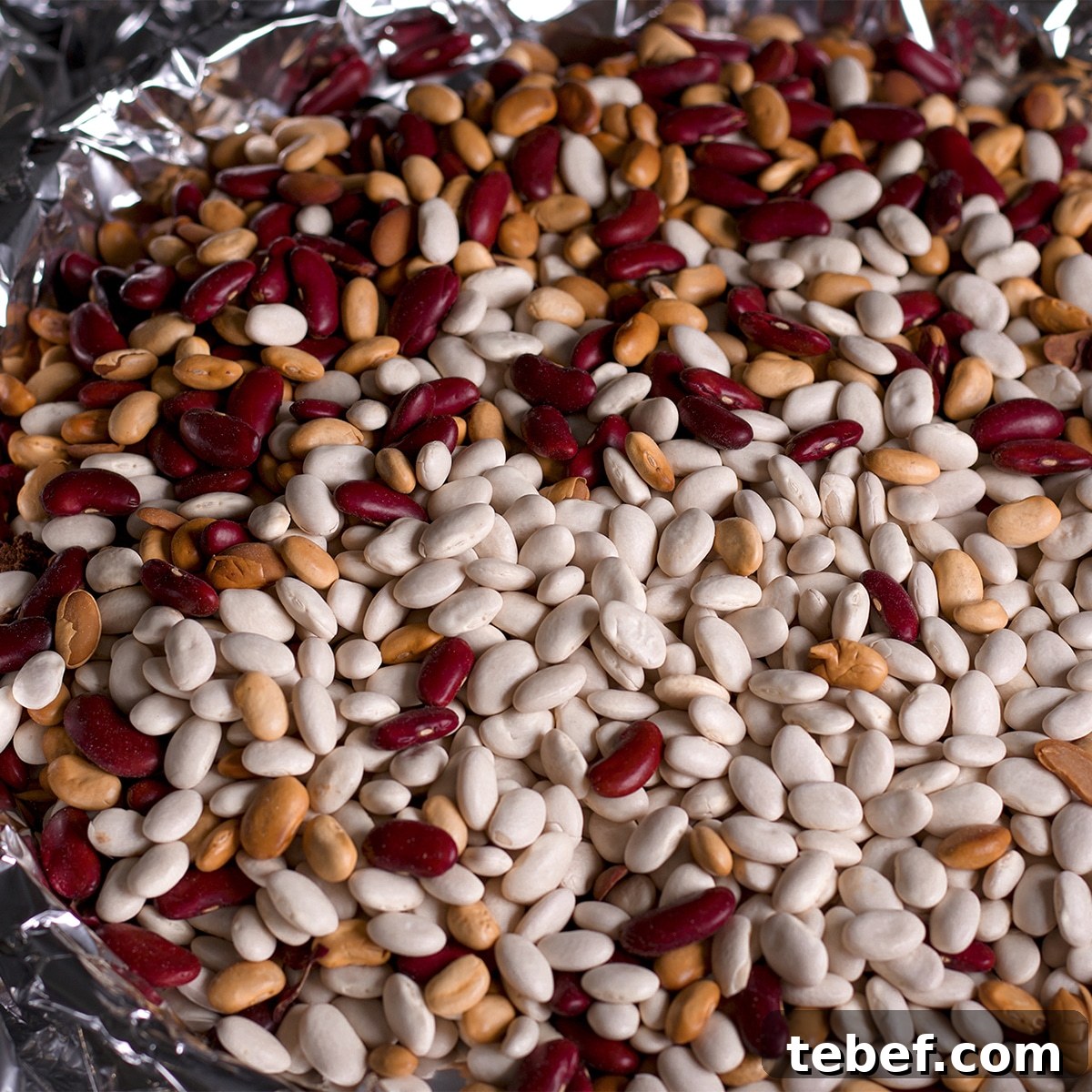 A tart pan that's been lined with pastry dough weighted down with dried beans so the pastry stays in place while baking.