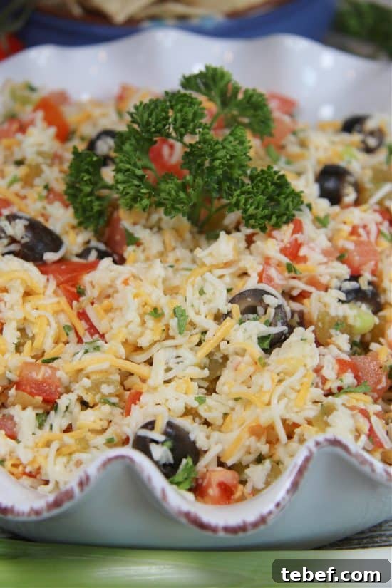 Creamy Jack Cheese Dip Recipe for Parties and Game Day 3 Parsley, black olives, and fresh tomatoes flavor this delicious appetizer served with tortilla chips.