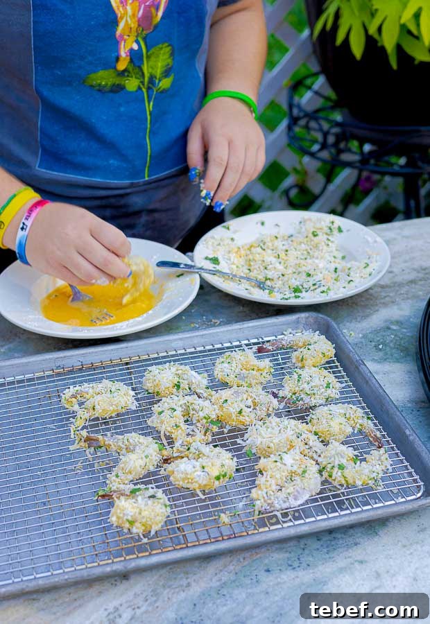 shrimp being dipped in flour, egg, than coconut before being grilled
