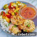 Crispy Grilled Coconut Shrimp with Peach Sauce and Coconut Sticky Rice on a grey plate