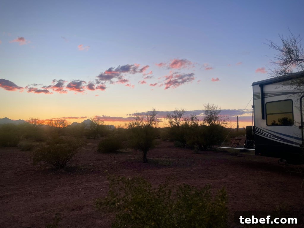 Lost Together: March 2022 Travel Stories and Highlights 12 Our 5th Wheel RV parked in Ironwood Forest National Monument with the sun setting in the background.