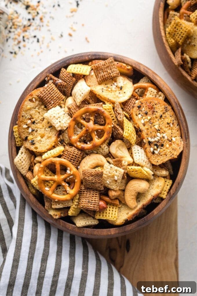 Everything Bagel Chex Mix Recipe — Crunchy Savory Snack Mix 2 Small wooden snack bowl filled with everything bagel Chex mix.