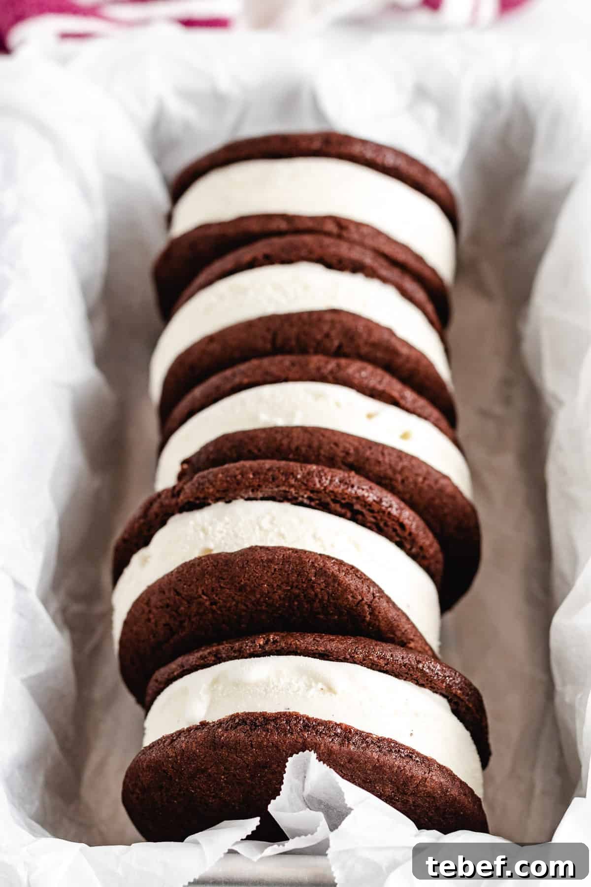 A row of ice cream sandwiches in a metal pan.
