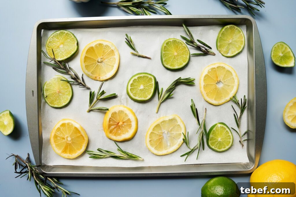 lemon, limes and rosemary on a baking sheet