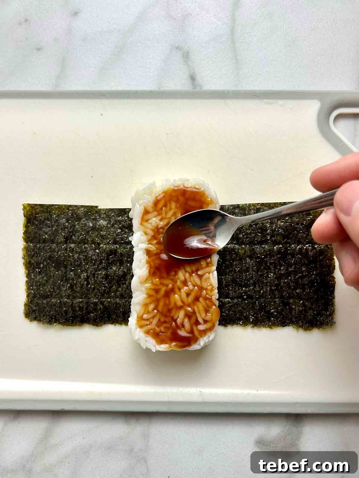 Chicken Katsu Musubi Recipe: How to Make Japanese Fried Chicken Rice Balls 13 tonkatsu sauce being spreaded onto rice