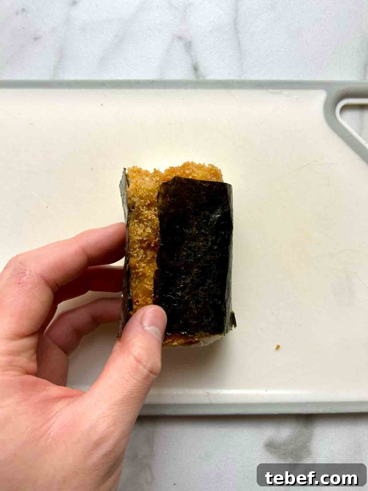 Chicken Katsu Musubi Recipe: How to Make Japanese Fried Chicken Rice Balls 15 musubi being wrapped