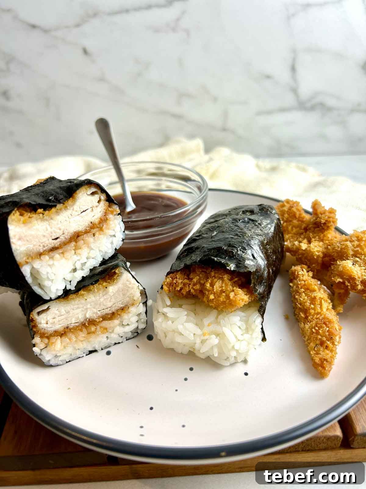 Chicken Katsu Musubi Recipe: How to Make Japanese Fried Chicken Rice Balls 16 side view of sliced chicken katsu musubi on plate