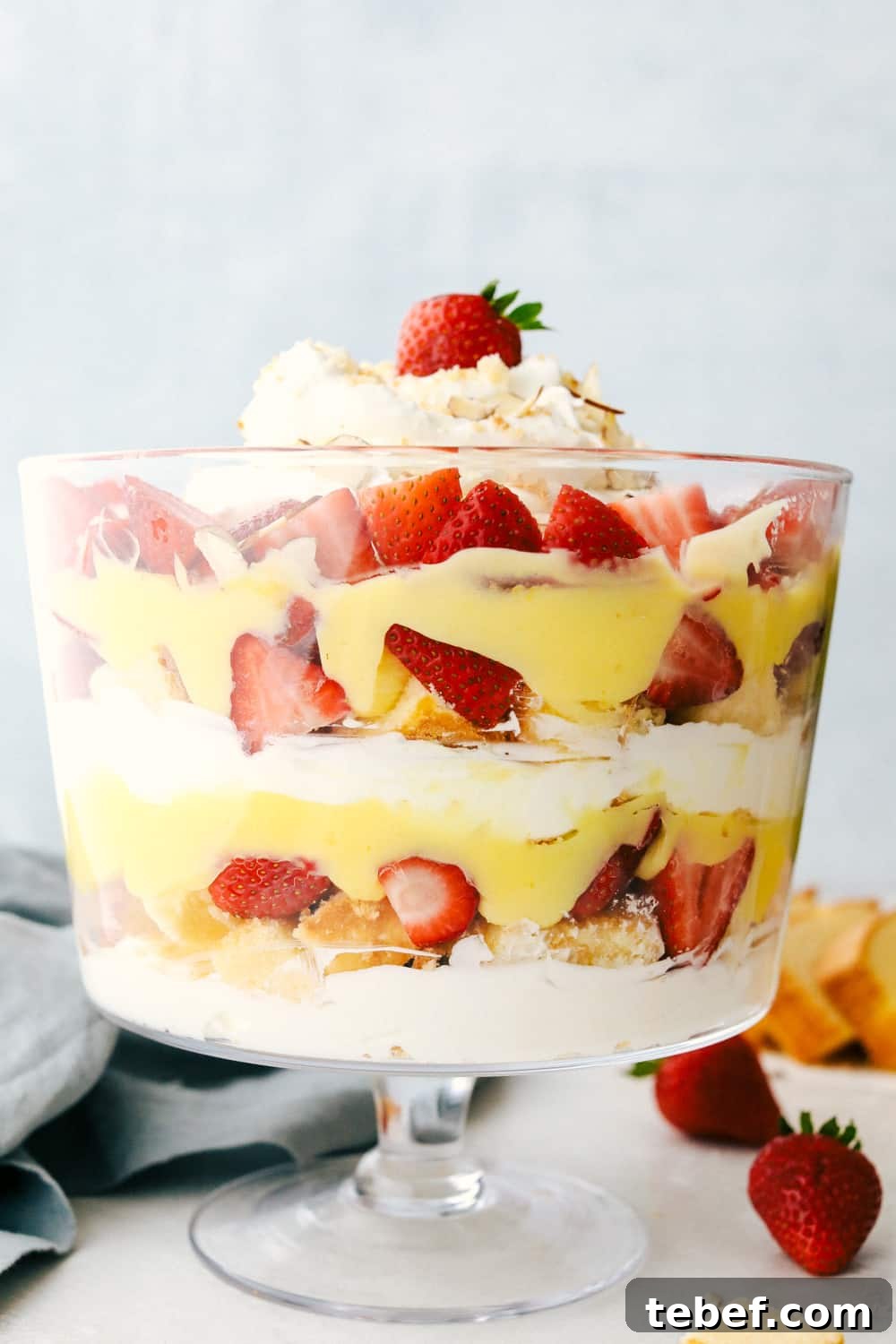 The English trifle in a tall glass dish layered together.