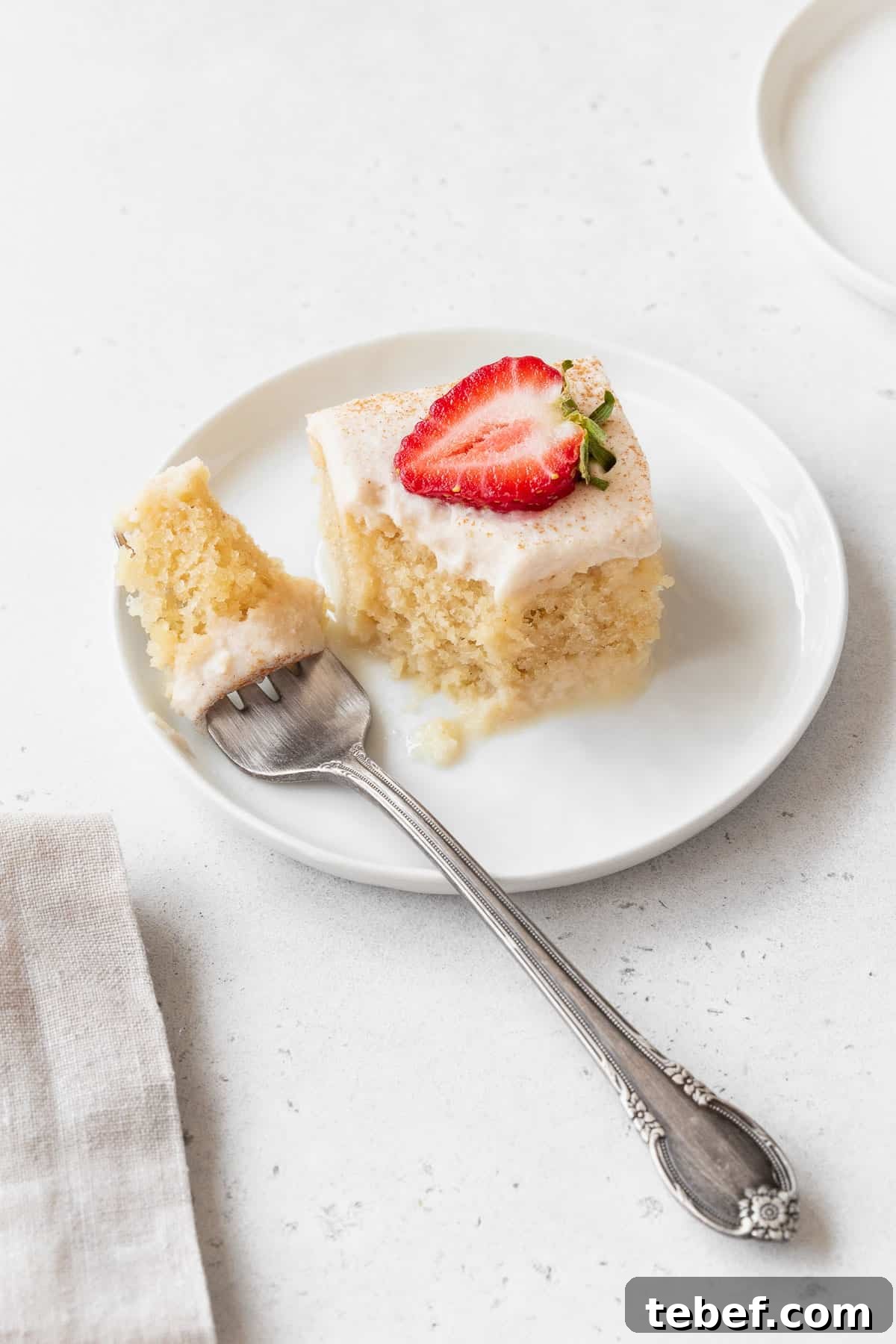 Taking a bite out of a piece of the gluten-free and dairy-free tres leches cake.