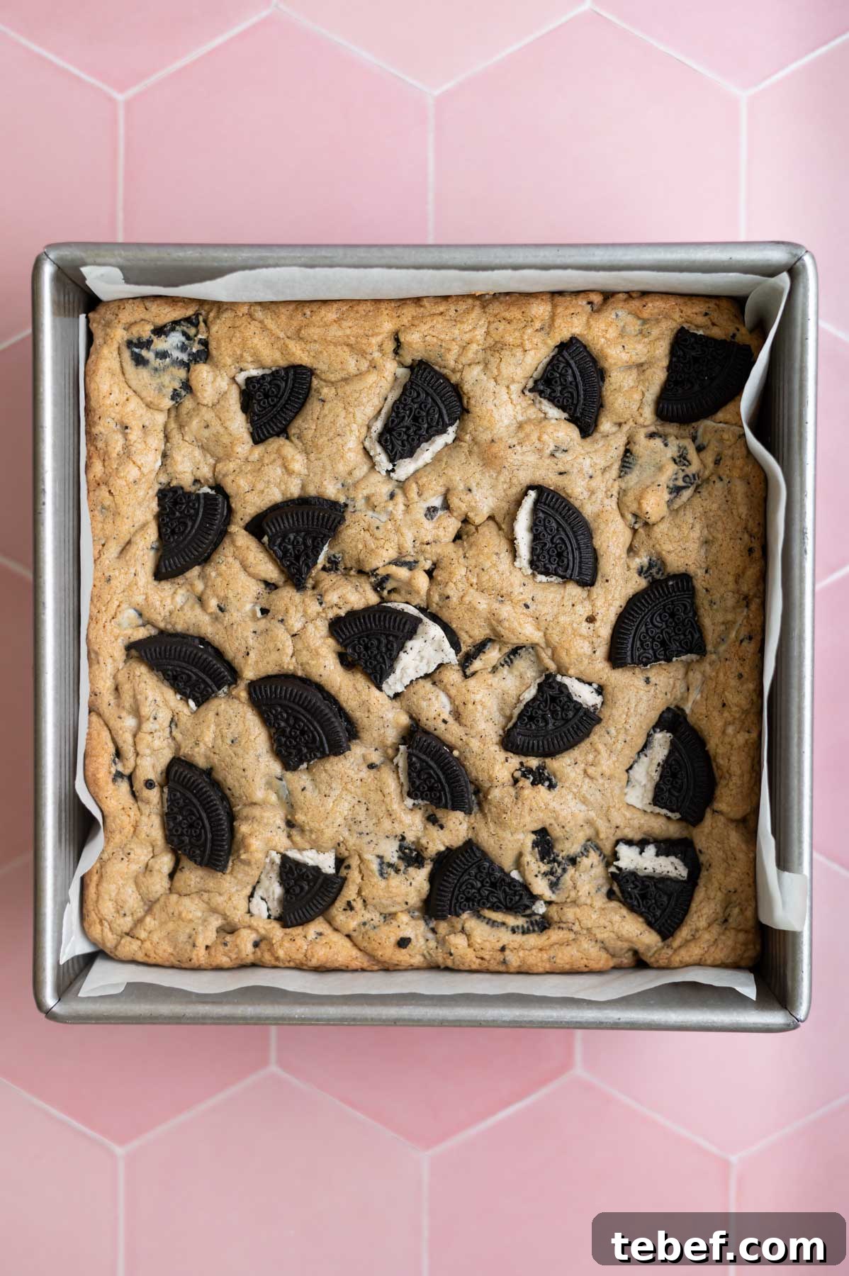 baked cookies and cream bars in a parchment lined baking pan