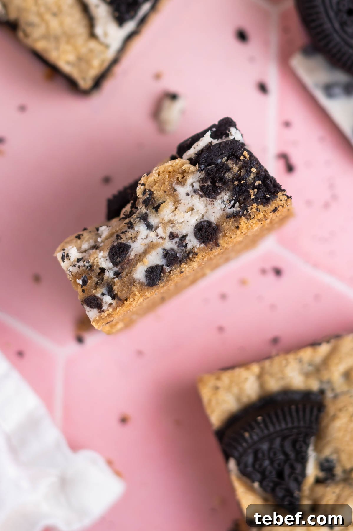cookies and cream bar on it's side showing the layers of candy bars and cookies inside
