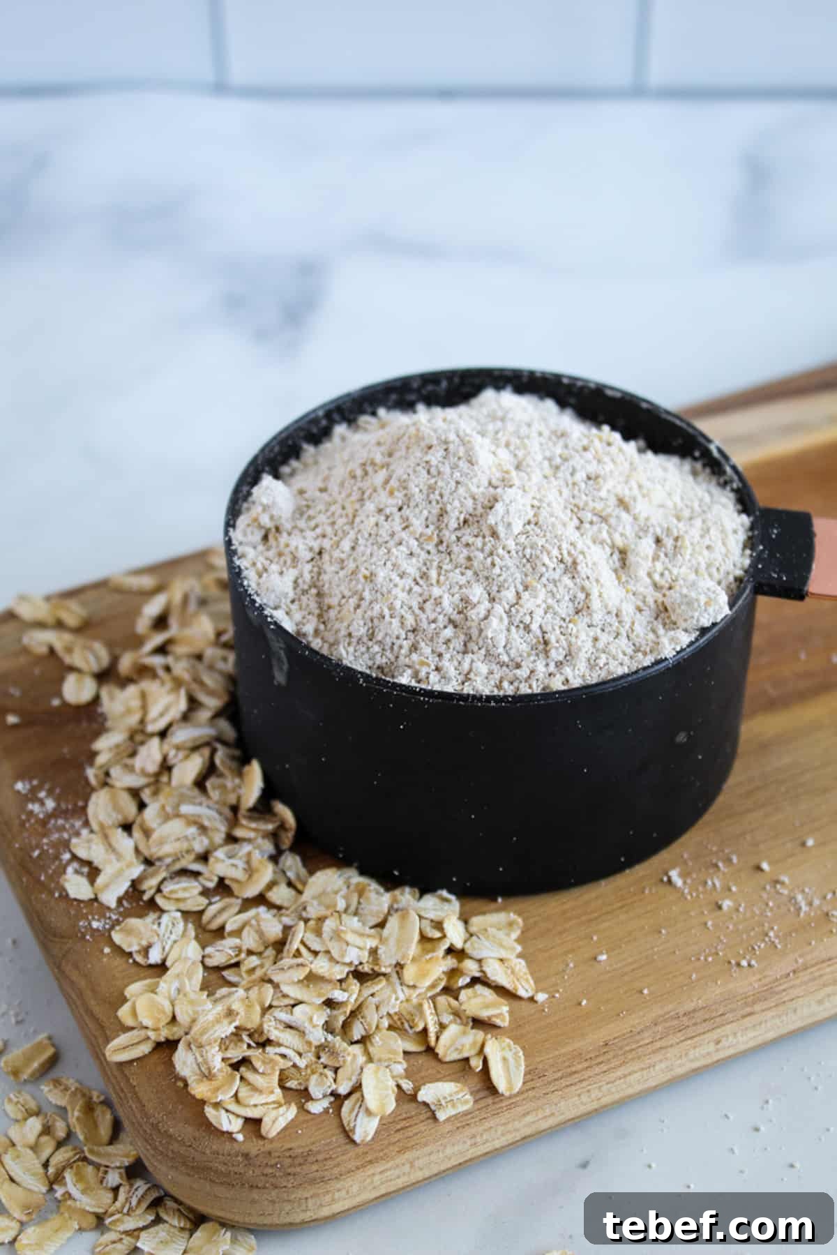 Almond Flour Substitutes: Top Alternatives and How to Use Them 3 black cup of oat flour on a cutting board