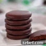 Gluten-Free Thin Mints: Girl Scout Cookie Copycat Recipe 13 stack of thin mints on white square plate with one broken in half.