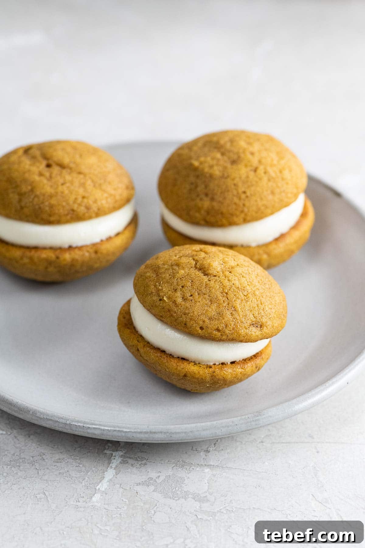 Mini Pumpkin Whoopie Pies with Cream Cheese Filling Recipe 2 mini pumpkin whoopie pies on a small plate