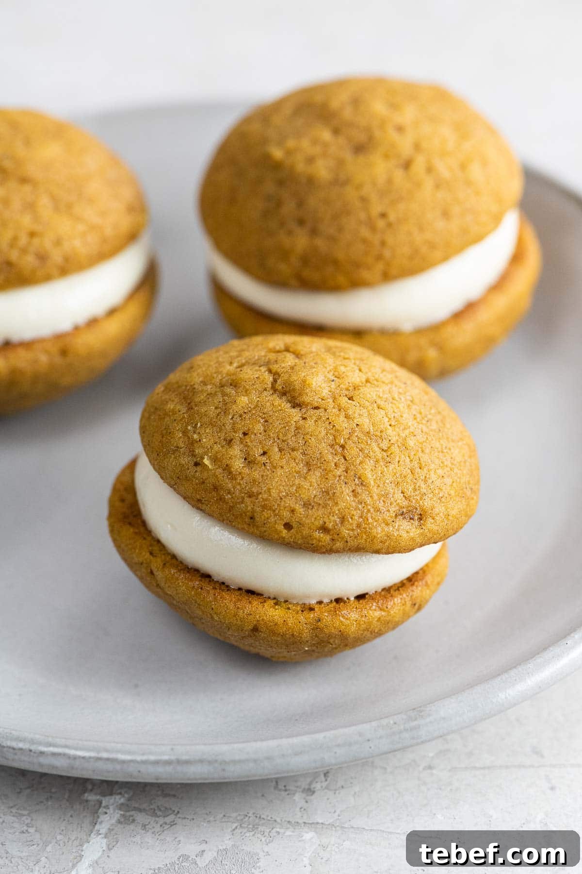 Mini Pumpkin Whoopie Pies with Cream Cheese Filling Recipe 8 mini pumpkin whoopie pies on a small plate