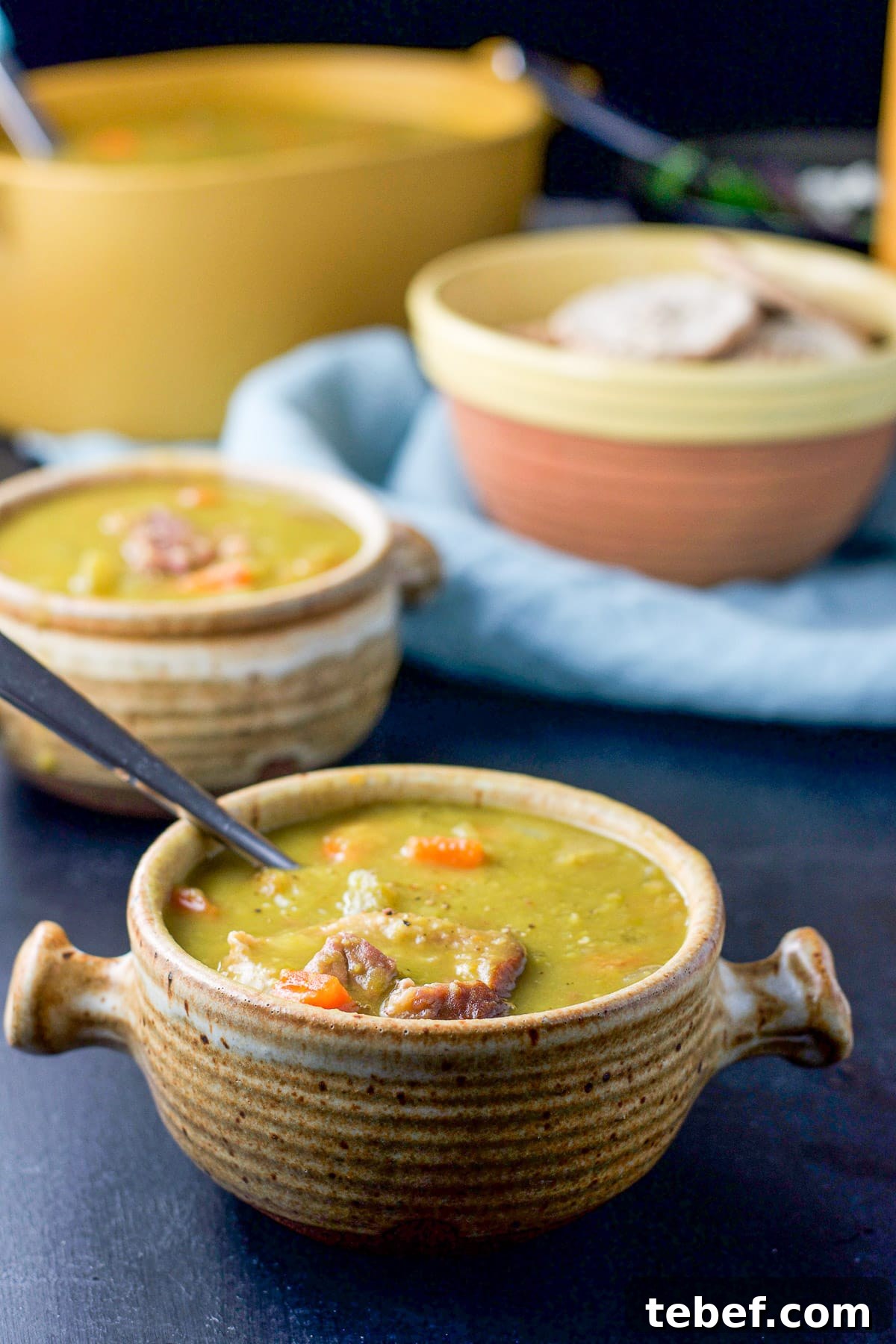 Instant Pot Split Pea Soup Recipe – Creamy, Hearty & Ready Fast 2 two crocks filled with pea soup with a serving bowl behind it