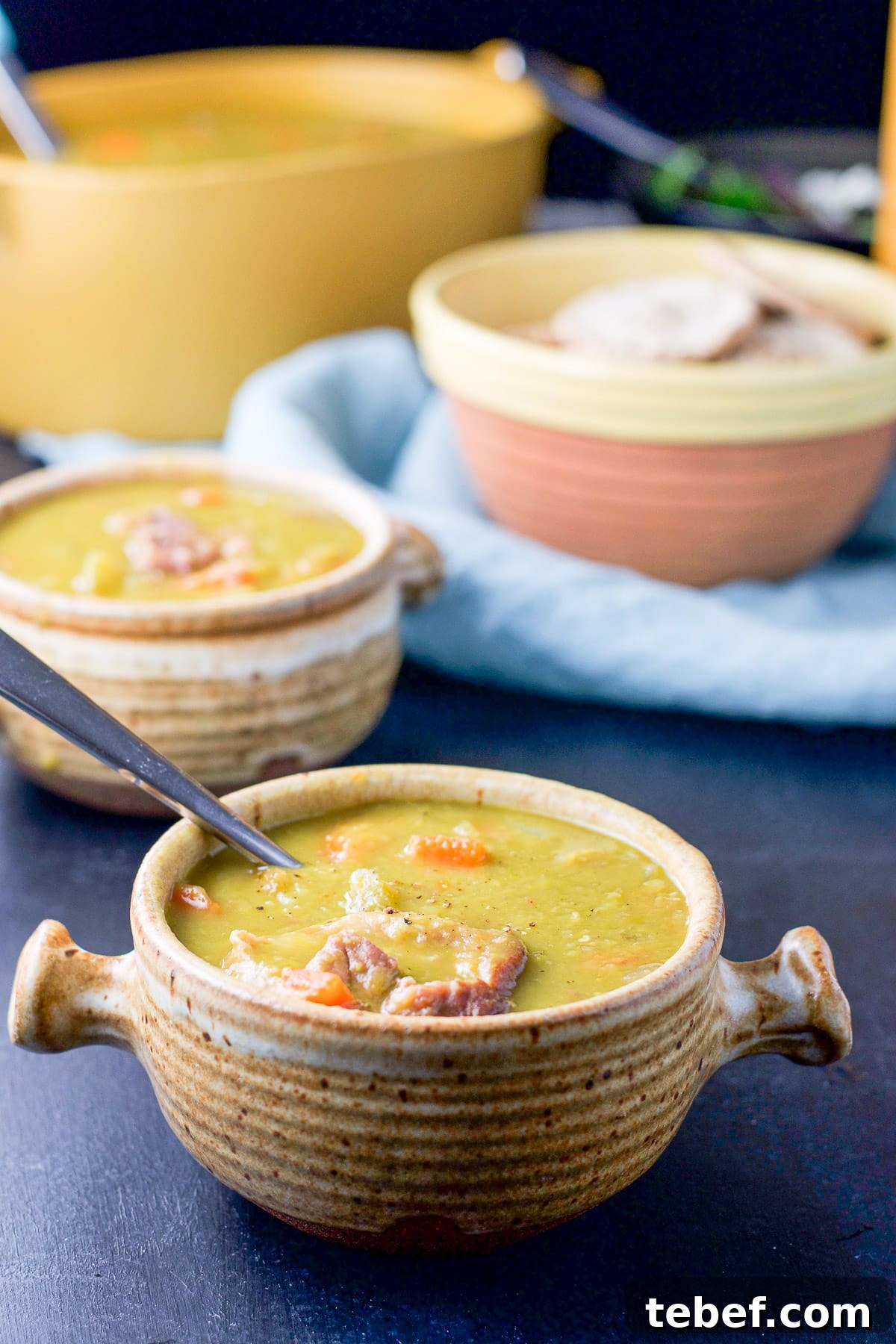 Instant Pot Split Pea Soup Recipe – Creamy, Hearty & Ready Fast 7 two crocks filled with the pea soup with pita and the serving bowl