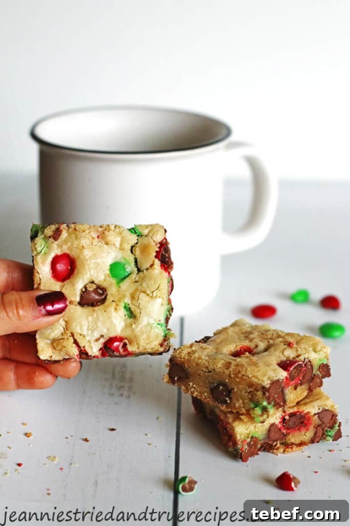 Chewy Cookie Bars Recipe: Gooey Chocolate Chip Squares 2 Cookie Bars on table next to a white mug