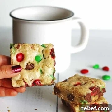 Chewy Cookie Bars Recipe: Gooey Chocolate Chip Squares 7 Cookie Bars on table next to a white mug
