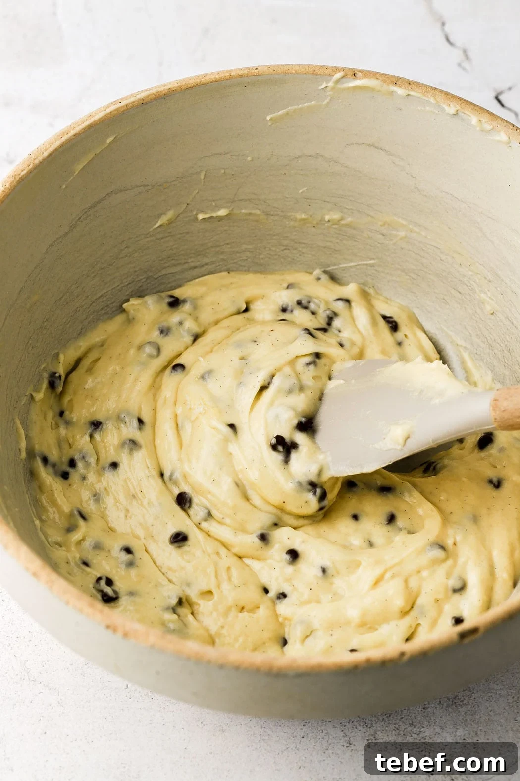 Bakery-Style Chocolate Chip Muffins Recipe That Delivers Flavor 7 fold in mini chocolate chips