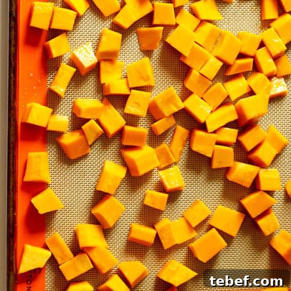 Roasted Pumpkin, Halloumi & Avocado Salad with Crispy Seeds 4 diced pumpkin on a baking tray
