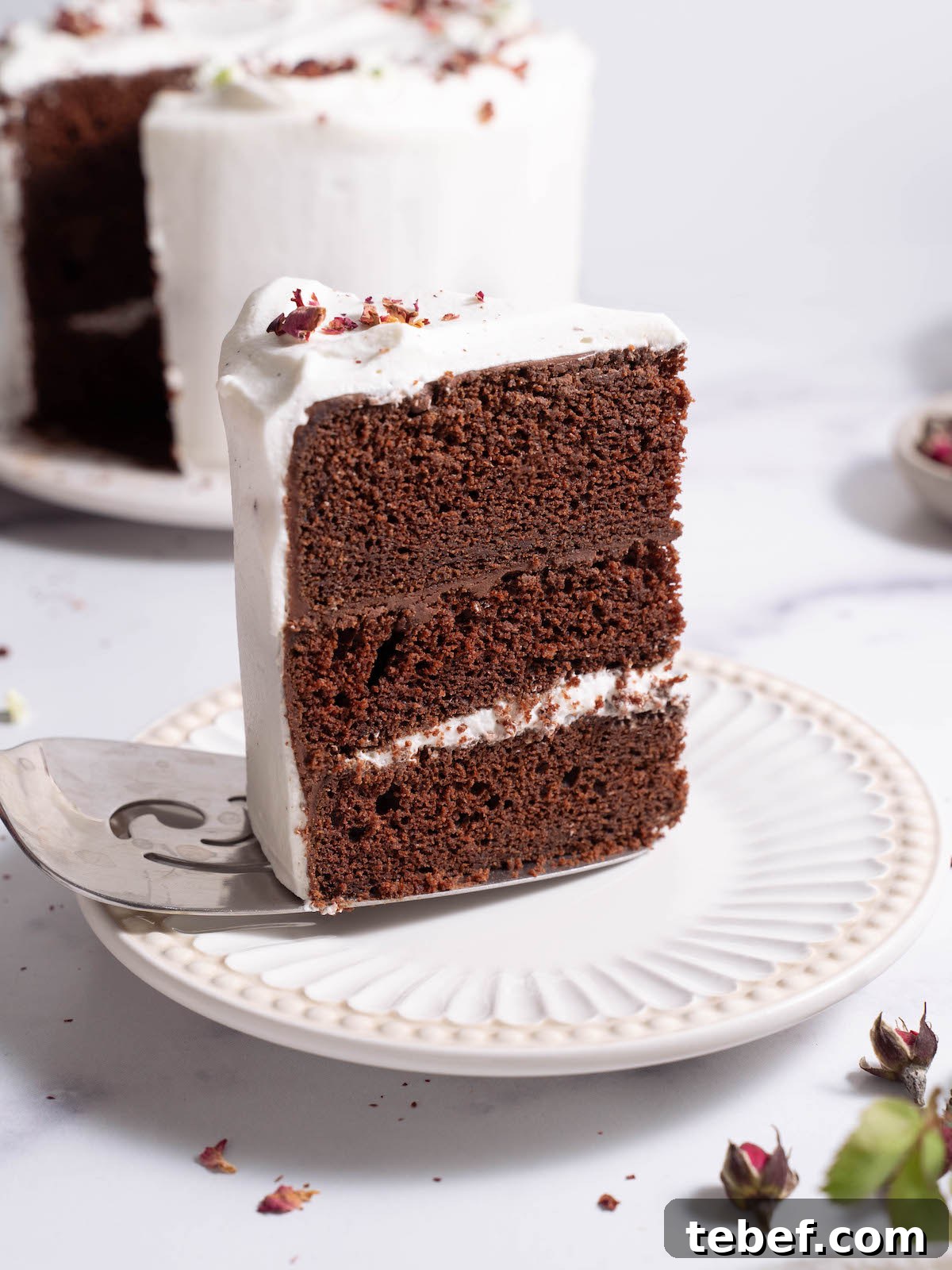 Chocolate Rose Cake with Vanilla Whipped Cream Recipe 2 A slice of chocolate rose cake being plated