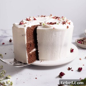 Chocolate Rose Cake with Vanilla Whipped Cream Recipe 9 A slice being taken out of a chocolate rose cake