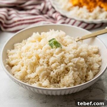 Perfect Instant Pot Jasmine Rice Recipe 11 Cooked jasmine rice with gold spoon in bowl.
