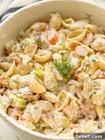 Creamy crab pasta salad with dill on top.
