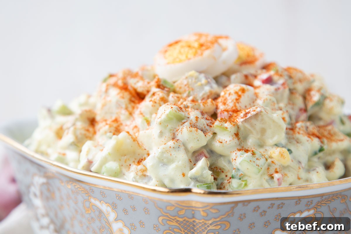 Creamy Red Potato Salad with Tangy Dill Dressing 5 red potato salad in a silver and white bowl.