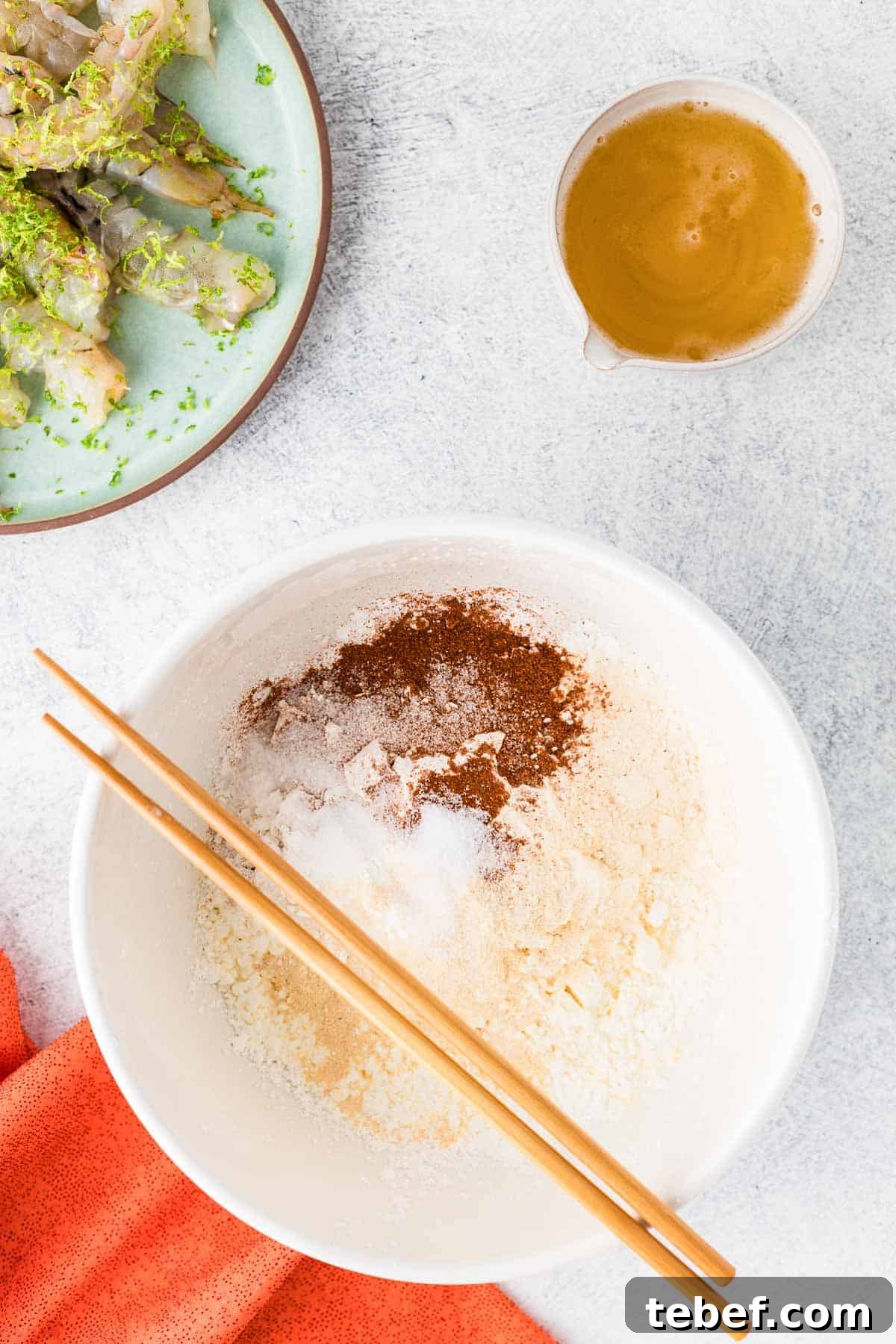 Crispy Beer-Battered Shrimp Recipe — Crunchy Fried Shrimp Guide 4 The dry ingredients for beer batter in a dish with chopsticks.