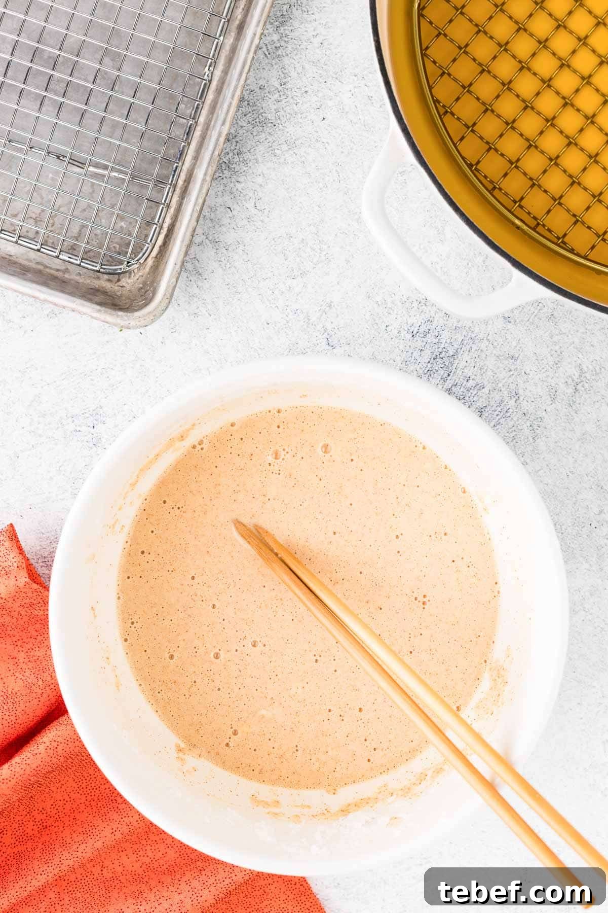 Crispy Beer-Battered Shrimp Recipe — Crunchy Fried Shrimp Guide 5 Components arranged on a counter: a bowl of batter, chopsticks, and a cooling rack.