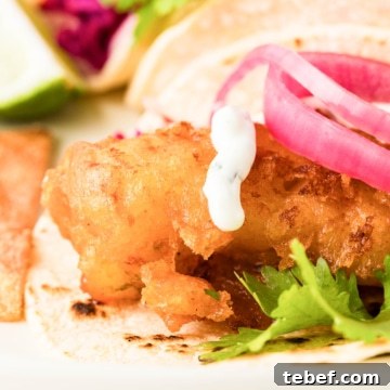 Close-up of beer-battered halibut in a taco.