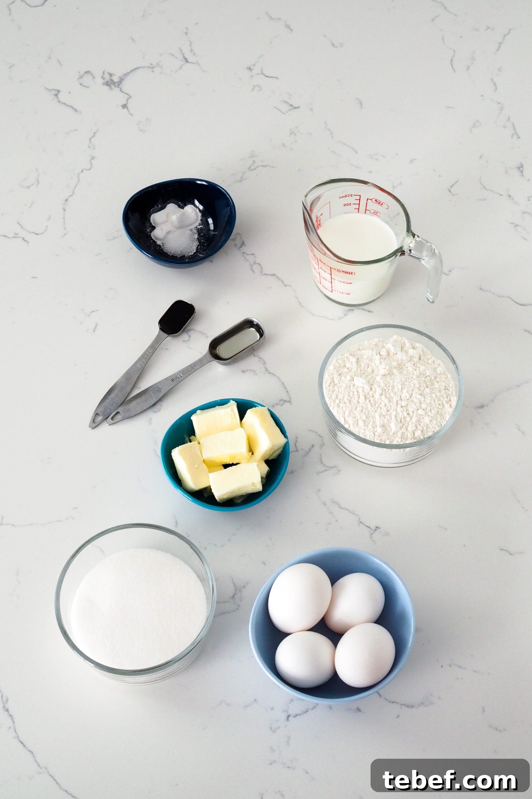 White Chocolate and Pomegranate Layer Cake Recipe 3 Ingredients needed to make the white cake laid out on a counter.