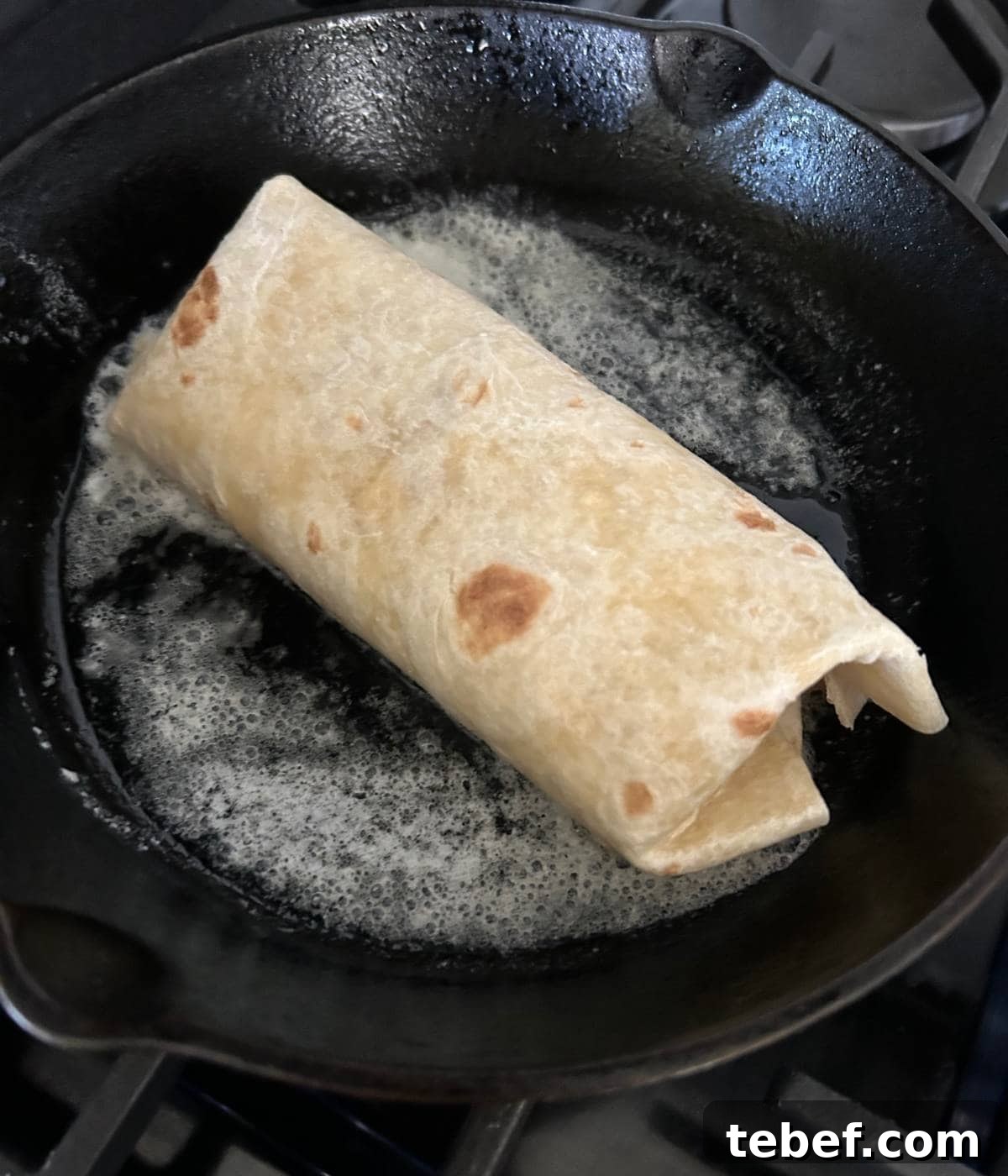 Classic Ham and Cheese Wrap Recipe for Quick Lunch or Snack 8 Hot ham and cheese toasting in pan with butter.