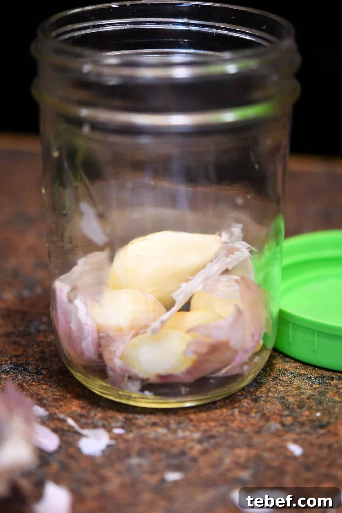 Creamy Zucchini Pasta Sauce Recipe for Light Weeknight Dinners 6 garlic cloves in a pint jar with little pieces of the peel remaining