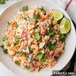 Mexican Macaroni Salad with Ham and Creamy Pepita Dressing 12 Mexican macaroni salad with ham in a bowl with some lime wedges.