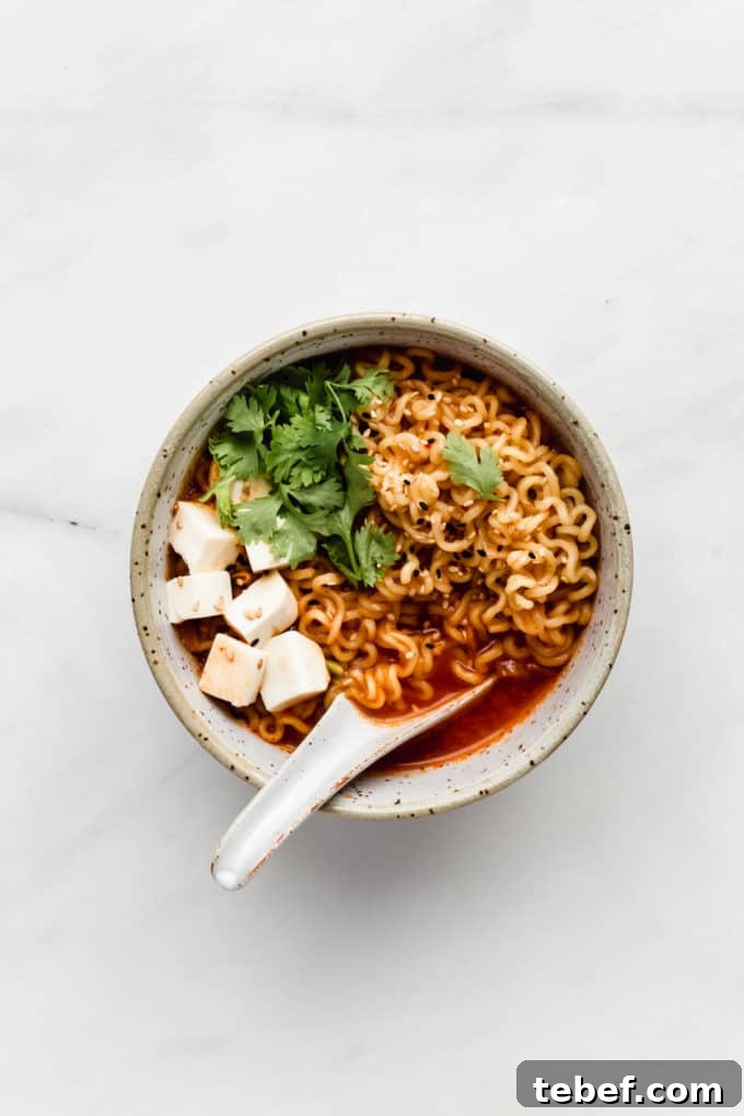 Authentic Kimchi Ramen Recipe: Spicy Korean Noodle Soup Guide 3 a bowl of kimchi ramen with tofu and cilantro