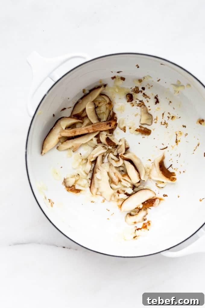 Authentic Kimchi Ramen Recipe: Spicy Korean Noodle Soup Guide 4 a white pot with mushrooms in it