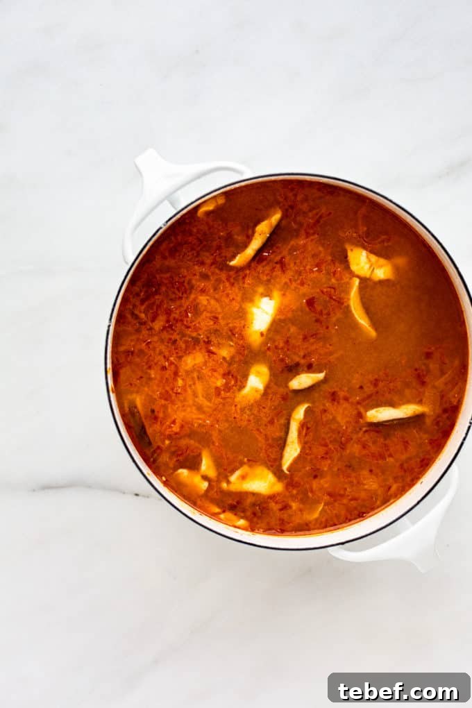 Authentic Kimchi Ramen Recipe: Spicy Korean Noodle Soup Guide 6 a white pot with kimchi ramen in it