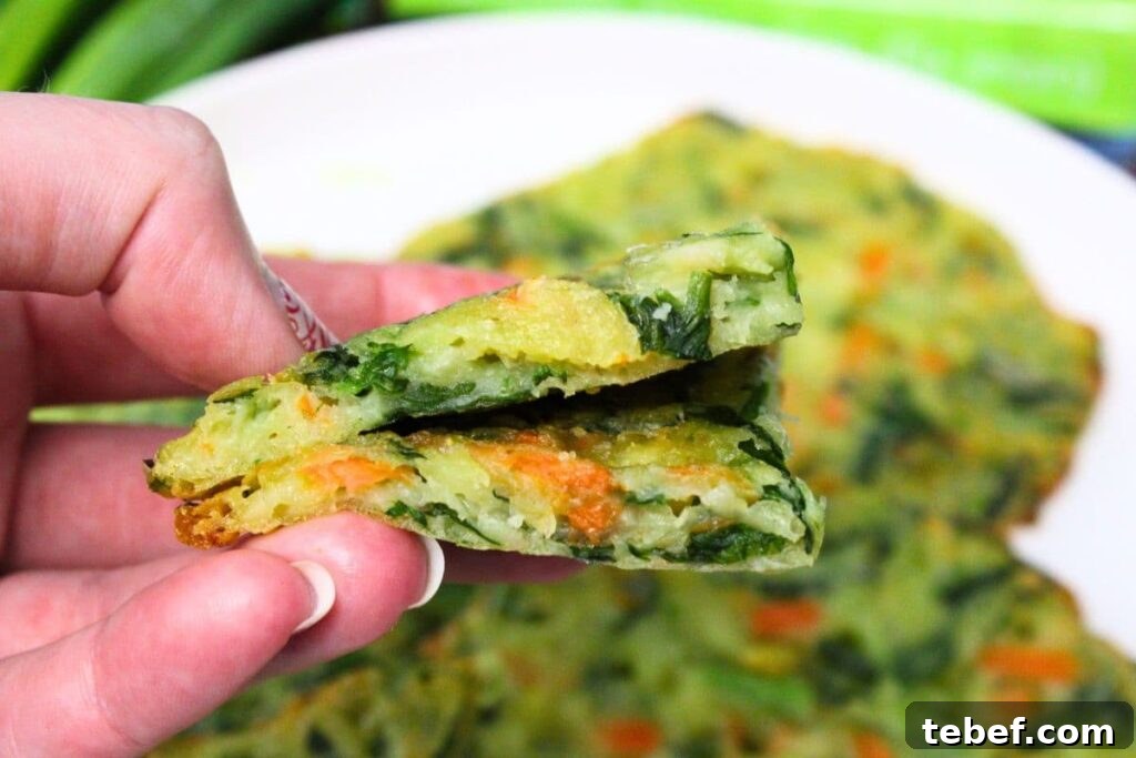 holding up two slices of trader joes scallion pancakes cooked in the air fryer